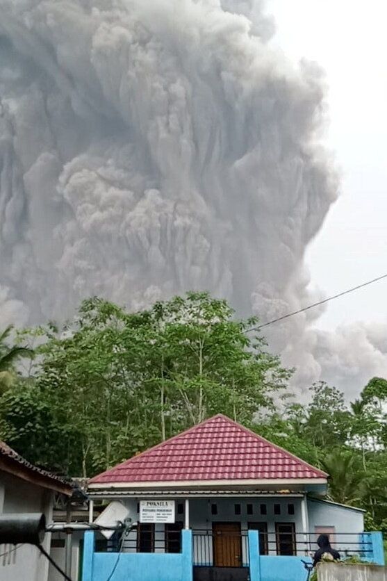 Mount Semeru volcano spews volcanic ash during an eruption as seen from Oro-oro Ombo, Pronojiwo district,...