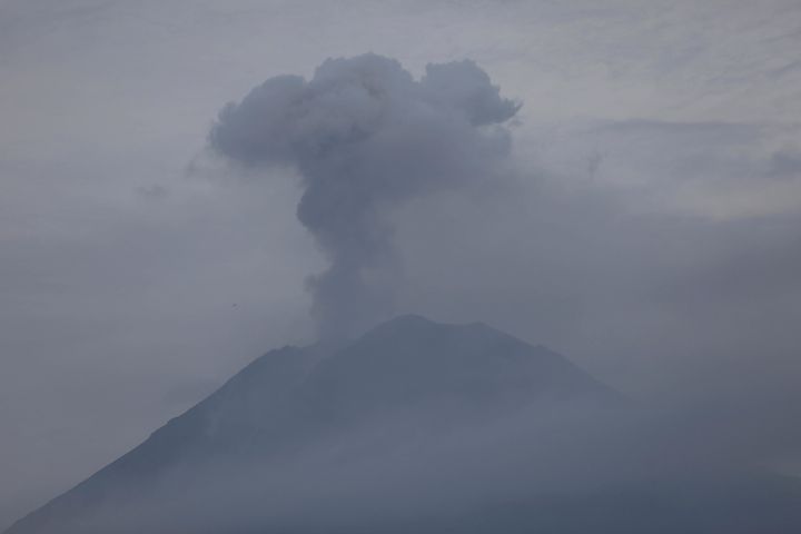 Mount Semeru releases volcanic materials during an eruption as seen from Lumajang, East Java, Indonesia, Sunday, Dec. 5, 2021. The highest volcano on Indonesia’s most densely populated island of Java spewed thick columns of ash, searing gas and lava down its slopes in a sudden eruption triggered by heavy rains on Saturday. (AP Photo/Trisnadi)