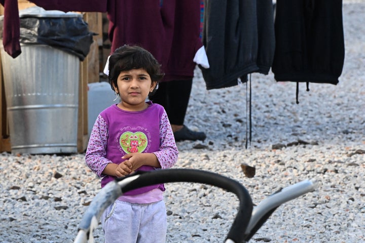 A child looks on at the Reception and Identification Centre (RIC) in Mytilene during the pope's visit on Sunday.