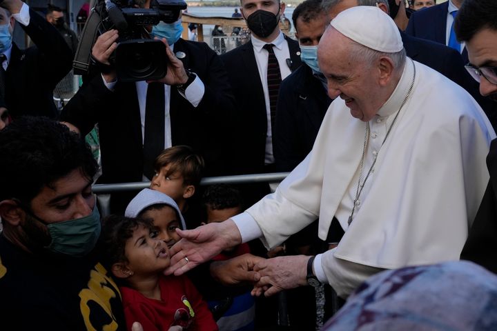 Pope Francis meets migrants during his visit at the Karatepe refugee camp in Greece on Sunday. He called for better treatment of refugees as attitudes towards immigrants harden across Europe.