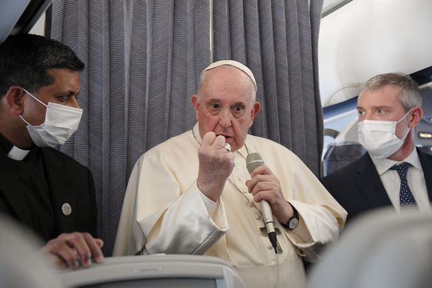 Pope Francis gives a news conference aboard the papal plane on his flight back to Rome after visiting Cyprus and Greece, on December 6, 2021. - Pope Francis thanked Greece for its 