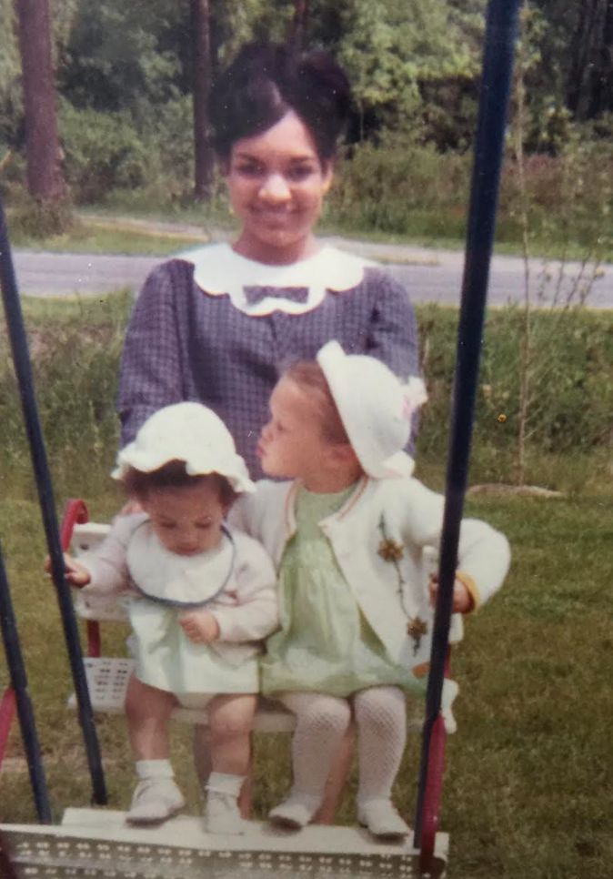 The author and her sister Suzette being swung by their mom in 1968.