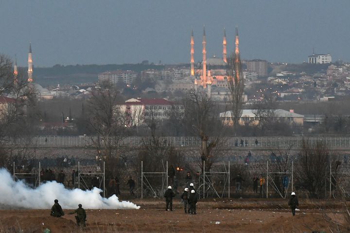 Greek riot police officers stand guard next to tear gas, as migrants are seen on the other side of the border fence, near Greece's Kastanies border crossing with Turkey's Pazarkule, with the city of Edirne seen in the background, in Kastanies, Greece March 7, 2020. REUTERS/Alexandros Avramidis