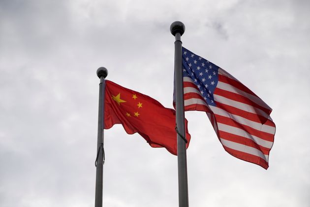 Chinese and U.S. flags flutter outside a company building in Shanghai, China November 16, 2021. REUTERS/Aly
