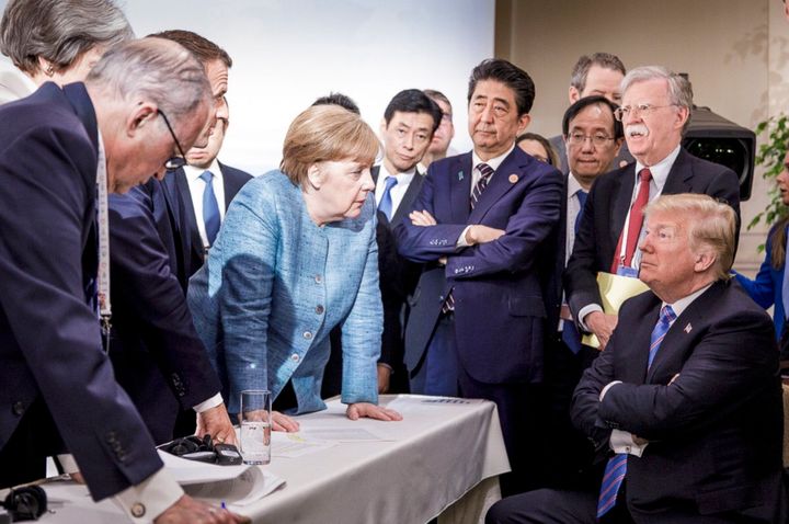 German Chancellor Angela Merkel, center, speaks with U.S. President Donald Trump, seated at right, during the G7 Leaders Summit in La Malbaie, Quebec, Canada, on June 9, 2018. 