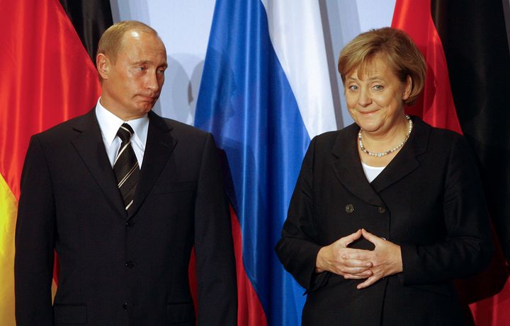 German Chancellor Angela Merkel, right, and Russian President Vladimir Putin hold a news conference after bilateral talks in Dresden, on Oct. 10, 2006. 