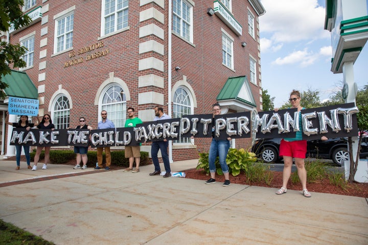 New Hampshire parents and other supporters gather outside of Sen. Maggie Hassan's office to thank her for child tax credit payments and demand they be made permanent on Sept. 14 in Manchester, New Hampshire.