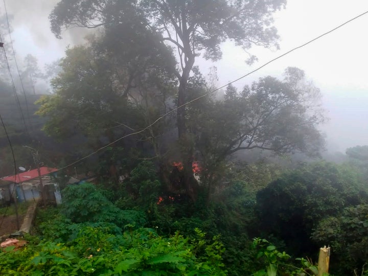 Smoke rises from fire after an army helicopter carrying India's Chief of Defense Staff Bipin Rawat crashed near Coonoor, Tamil Nadu state, India, on Dec. 8, 2021. 