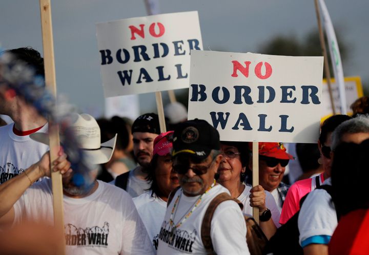 People are seen demonstrating against the construction of a border wall on the Rio Grande that separates Texas from Mexico in Mission, Texas, in 2017.