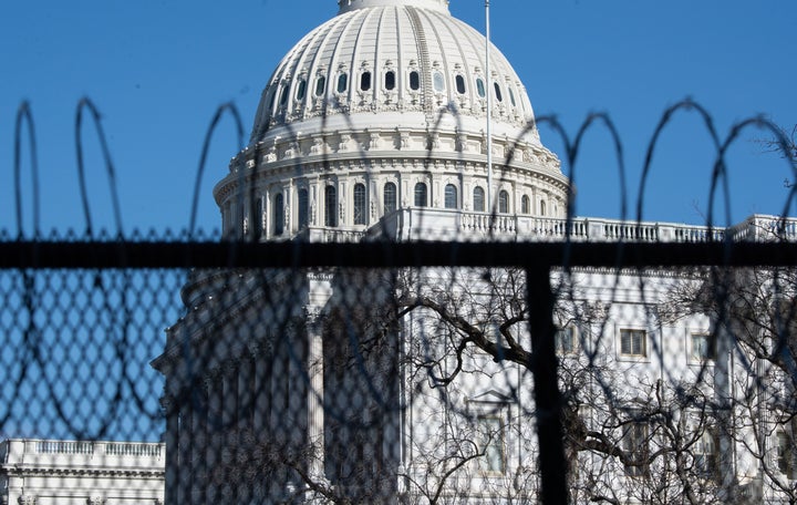 A barbed-wire fence surrounds the U.S. Capitol on Jan. 14, a week after a crowd of Donald Trump supporters attacked the building on Jan. 6.