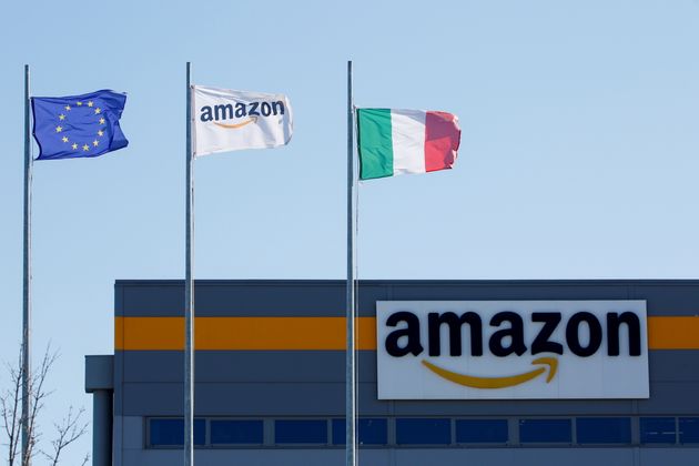 Flags flutter outside a distribution centre, during a strike at Amazon's logistics operations in Italy,...