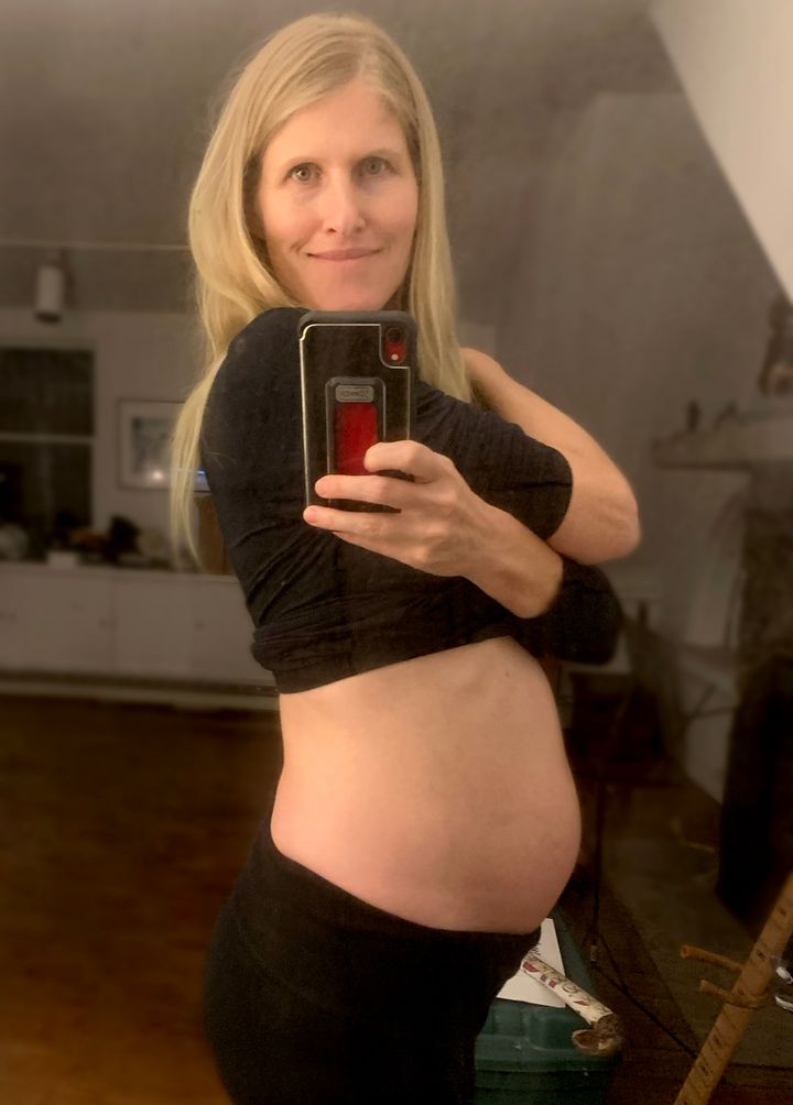 The author at 22 weeks pregnant. "Finally starting to show," she writes.