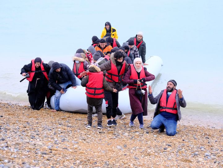 People landing on a British beach in November after travelling across the English Channel in a dinghy