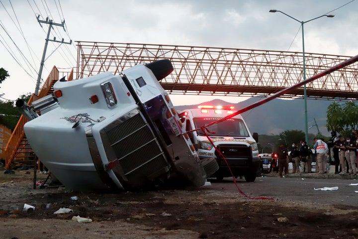 A truck that was transporting as many as 200 people from Central America is seen rolled over after a traffic accident on Dec. 9, 2021, in Tuxtla Gutierrez, Mexico.