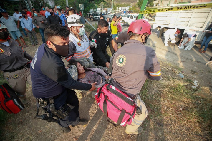 An injured woman is moved by rescue personnel from the site of an accident near Tuxtla Gutierrez, Chiapas state, Mexico on Dec. 9, 2021.
