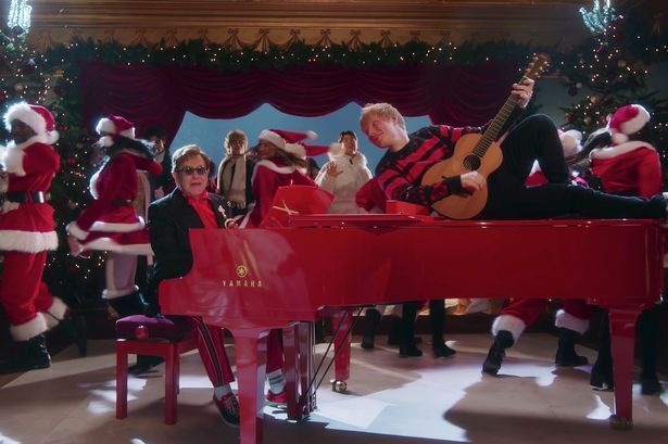Elton John and Ed Sheeran in the music video for their number one hit Merry Christmas