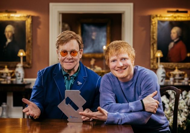 Elton John and Ed Sheeran celebrating their number one single together