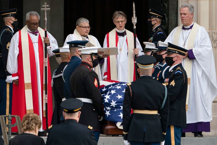 The flag-draped casket of former Sen. Bob Dole is carried into the Washington National Cathedral for a funeral service, Friday, Dec. 10, 2021, in Washington. Chairman of the Joint Chiefs Mark Milley, bottom second from left, stands with former Sen. Elizabeth Dole, left. (AP Photo/Manuel Balce Ceneta)