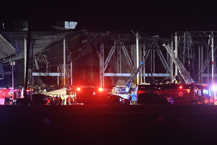 First responders surround a heavily damaged Amazon Distribution Center in Edwardsville, Illinois, Friday night after the building partially collapsed when violent storms, including a tornado, ripped through the area.
