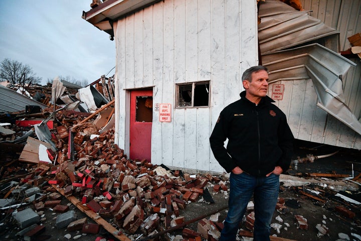 Gov. Bill Lee surveys tornado damage outside the fire department in Dresden, Tenn., Saturday, Dec. 11, 2021. (George Walker IV/The Tennessean via AP)