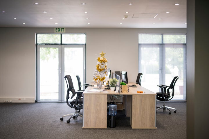 Xmas tree on a table in an empty coporate office with nobody around