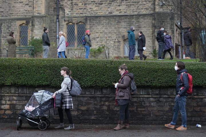 People queue for Covid-19 vaccines and boosters at Saint Oswald's Church Centre on December 13, 2021 in Sheffield.