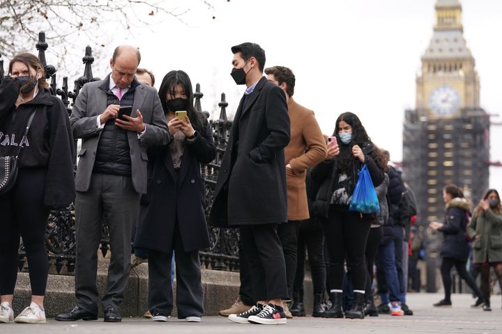 People queuing on Westminster Bridge for booster jabs at St Thomas' Hospital, London.