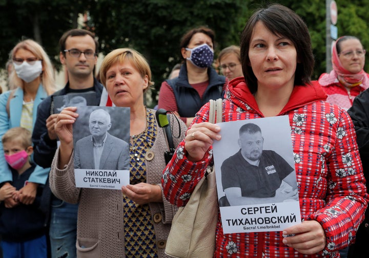 People hold portraits of arrested opposition figures Syarhei Tsikhanouski and Nikolai Statkevich during a demonstration to protest against presidential election results, in front of the Janka Kupala National Academic Theatre in Minsk, Belarus August 28, 2020. REUTERS/Vasily Fedosenko