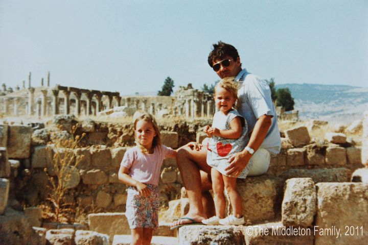 In this photo provided by Clarence House, Kate Middleton poses with her sister Pippa and father Michael in Jerash, Jordan.