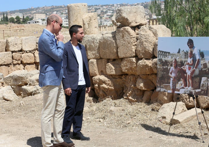 Prince William and Jordanian Crown Prince Hussein bin Abdullah look at an enlarged photograph showing Kate Middleton and her family posing in the ruins of Jerash in the 1980s. The photograph was displayed during William's tour to the archaeological site on June 25, 2018.