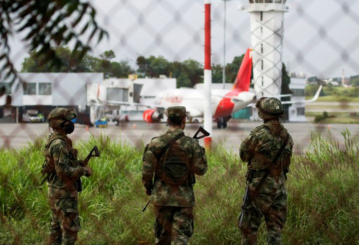 Soldiers stand guard at a crime scene after two explosions at the international airport Camilo Daza killed several people, in Cucuta, Colombia December 14, 2021. Picture taken through a fence. REUTERS/Stringer