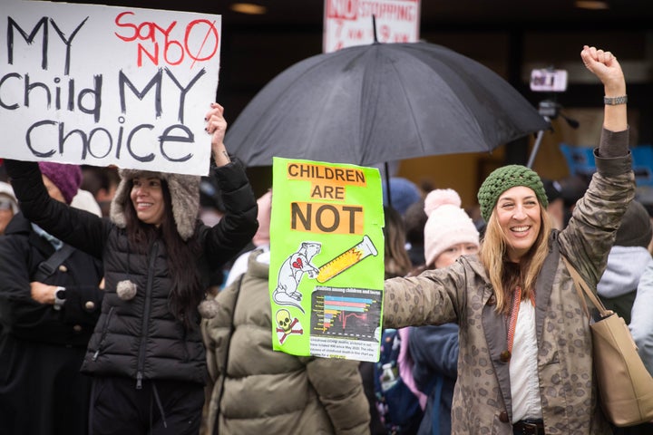 Parents opposed to LAUSD's student vaccine mandate rally outside the district office in Los Angeles while the school board met on enforcement of the mandate on Tuesday.