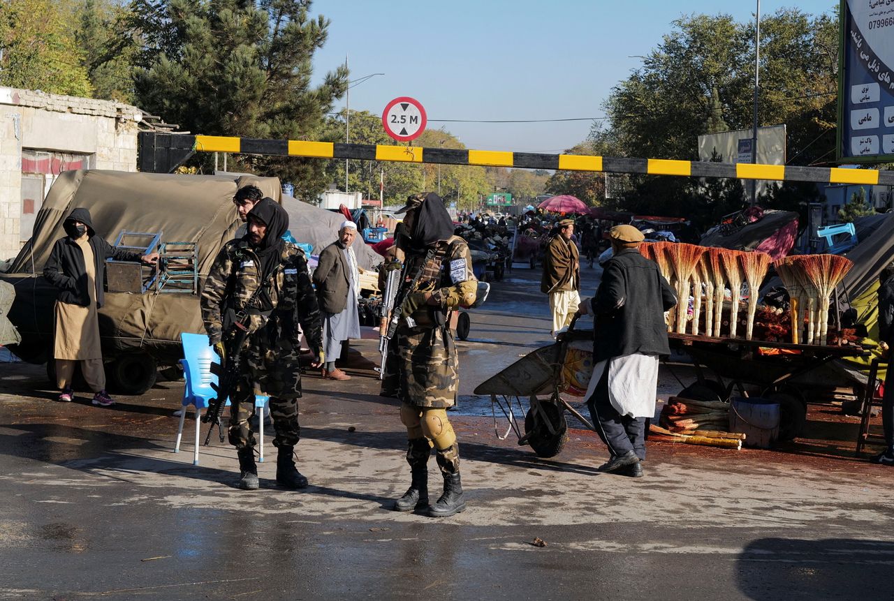 Taliban fighters stand at a checkpoint in Kabul, Afghanistan.