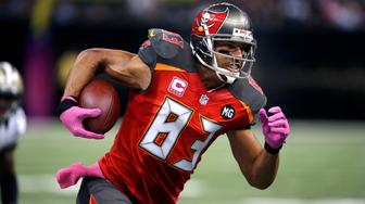 FILE - In this Oct. 5, 2014, file photo, Tampa Bay Buccaneers wide receiver Vincent Jackson (83) runs with the ball in the second half of an NFL football game against the New Orleans Saints in New Orleans. Florida authorities are looking into the death of former Buccaneers player Jackson, who was found dead Monday, Feb. 15, 2021, at a Florida hotel room. (AP Photo/Bill Haber, File)