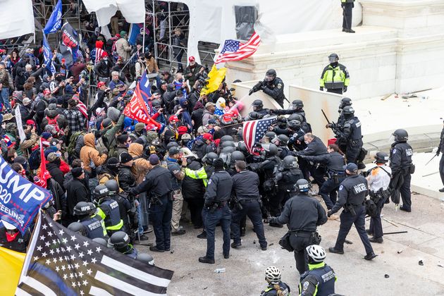 Pro-Trump protesters and police clash on top of the Capitol building on Jan. 6, 2021.