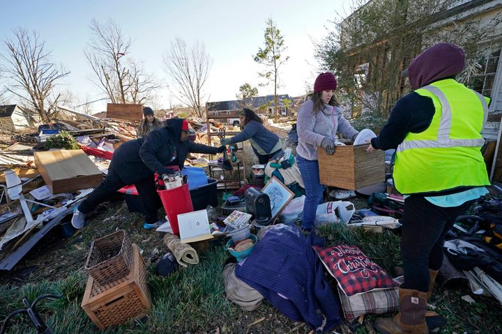 Volunteers, mostly from the Mayfield Consumer Products factory, help salvage possessions from a destroyed home.