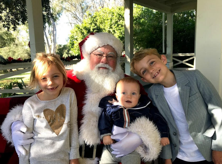 Aiden (center), with his brother Owen and sister Peyton, visiting Santa for the first and only time.