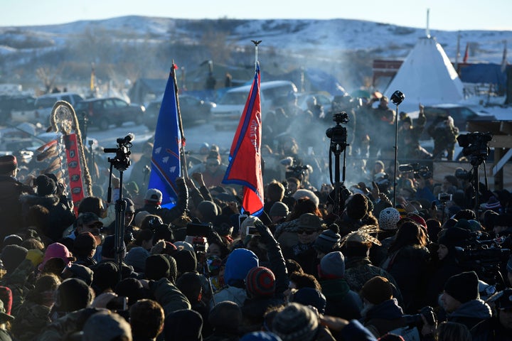 Protesters at Oceti Sakowin camp in Cannon Ball North Dakota celebrate on Dec. 4, 2016, after Sioux Chief Arvol Looking Horse announced to members of over 300 nations that the U.S. Army Corps of Engineers would no longer grant access to build the Dakota Access Pipeline on the boundary of the Standing Rock Sioux Reservation. Native Americans and activists from around the country had been gathering at the camp for several months trying to halt the construction of the pipeline.