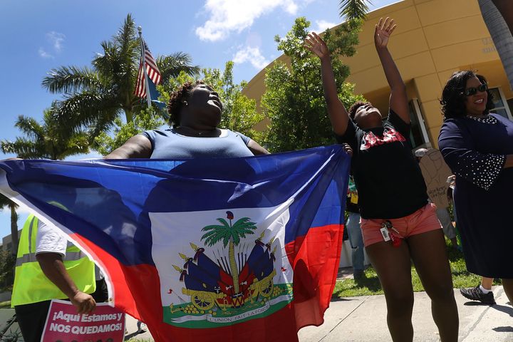Francesca Menes, left, and others protest in front of the U.S. Citizenship and Immigration Services office in Broward County, Florida, on May 21, 2017, to urge the Department of Homeland Security to extend Temporary Protected Status for Haitian immigrants.
