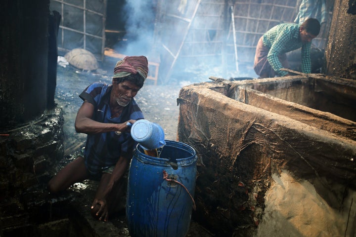 Laborers work at a leather processing factory in the Hazaribag area in Dhaka, Bangladesh on Friday, Feb. 5, 2021.