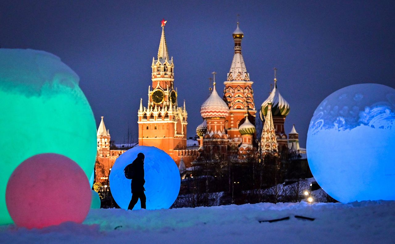 A pedestrian walks past Christmas and New Year's decorations at Zaryadie Park, in front of the Spasskaya tower of the Kremlin and Saint Basil's Cathedral in central Moscow on Wednesday.