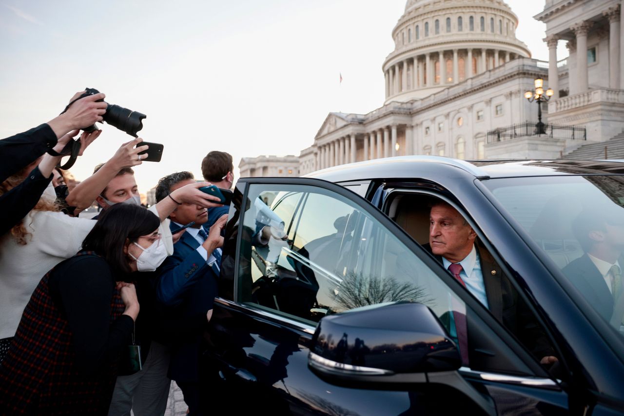 Sen. Joe Manchin (D-W.Va.) is followed to his car by reporters after participating in a vote at the U.S. Capitol Building on Tuesday in Washington, D.C.
