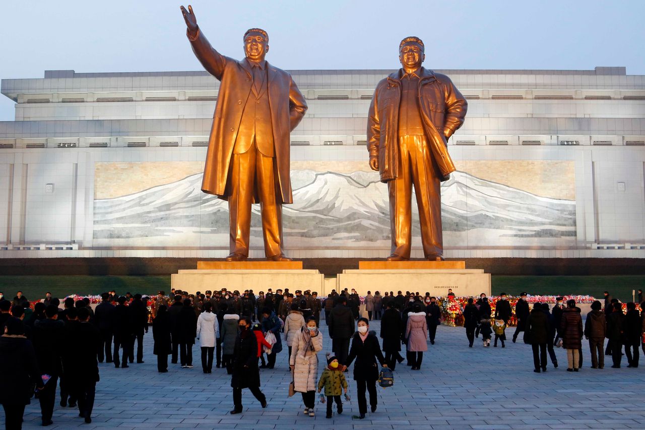 Citizens visit the bronze statues of their late leaders Kim Il Sung, left, and Kim Jong Il on Mansu Hill in Pyongyang, North Korea, Thursday on the 10th anniversary of the death of Kim Jong Il.