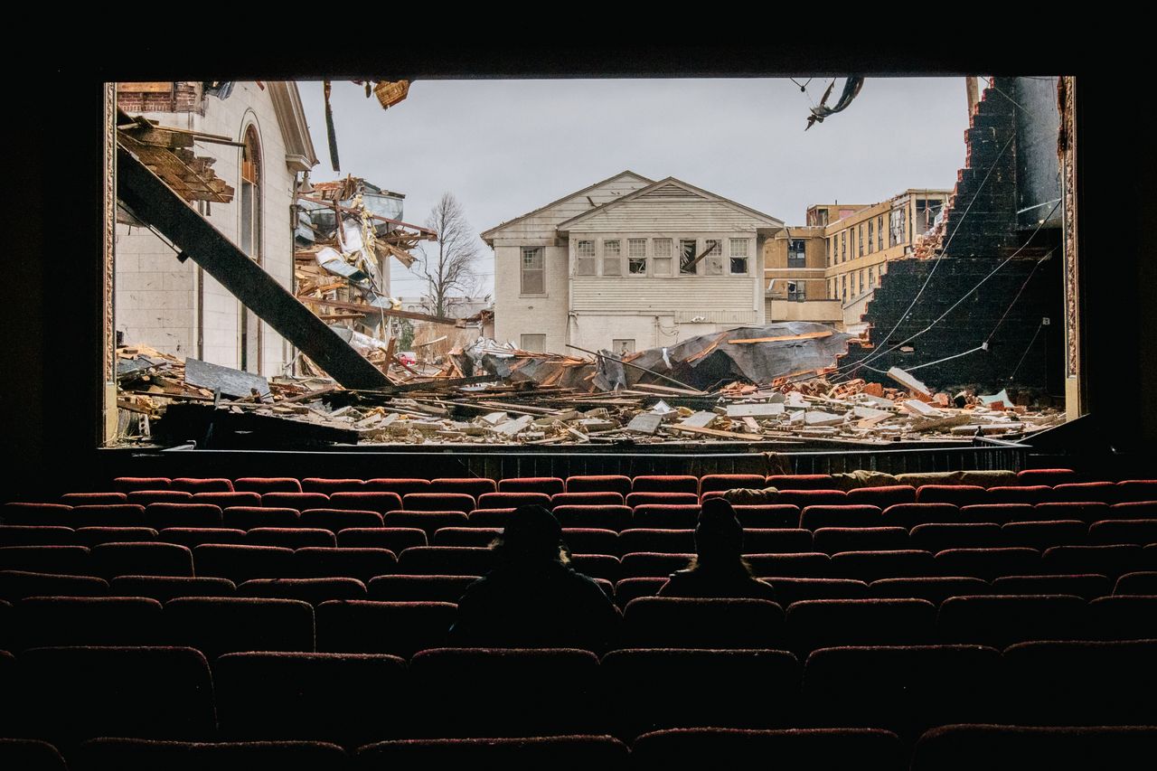 Photographers sit in the American Legion theatre on Thursday in Mayfield, Kentucky. Multiple tornadoes struck several Midwest states late evening on Dec. 10, causing widespread destruction and multiple casualties.