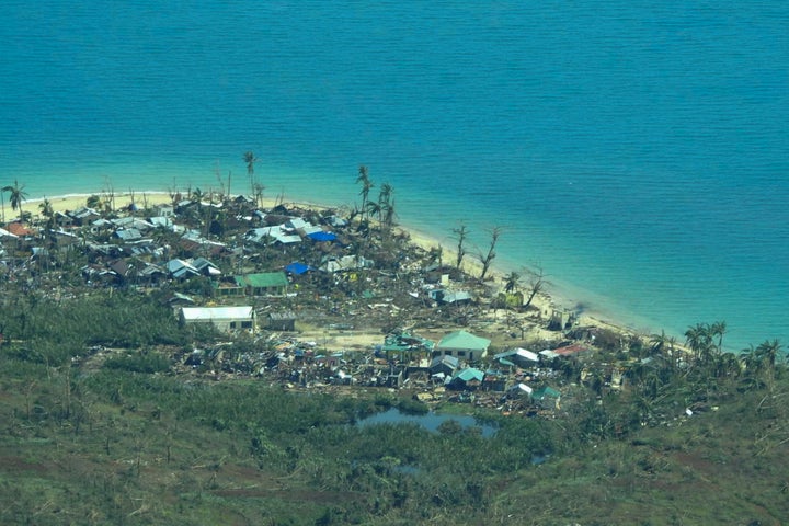 A strong typhoon engulfed villages in floods that trapped residents on roofs, toppled trees and knocked out power in southern and central island provinces, where more than 300,000 villagers had fled to safety before the onslaught.