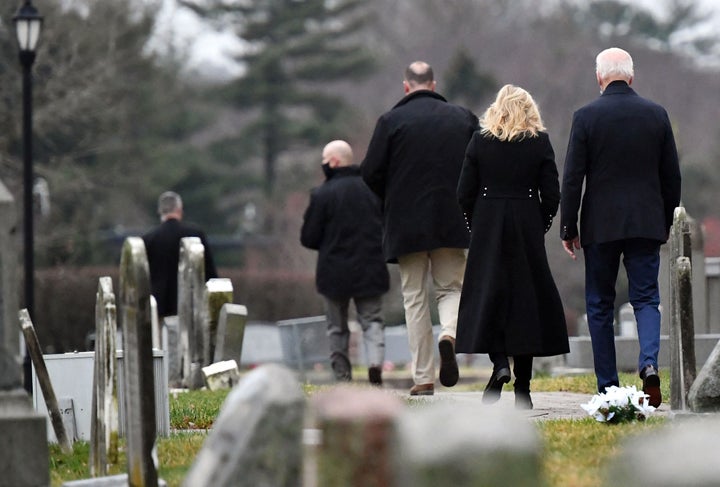 President Joe Biden and First Lady Jill Biden walk in the graveyard at St. Joseph on the Brandywine Catholic Church.