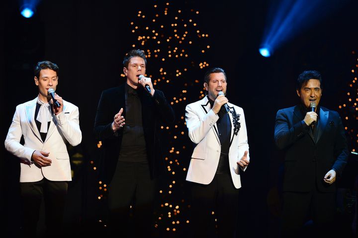 Carlos (right) on stage with Il Divo in 2019