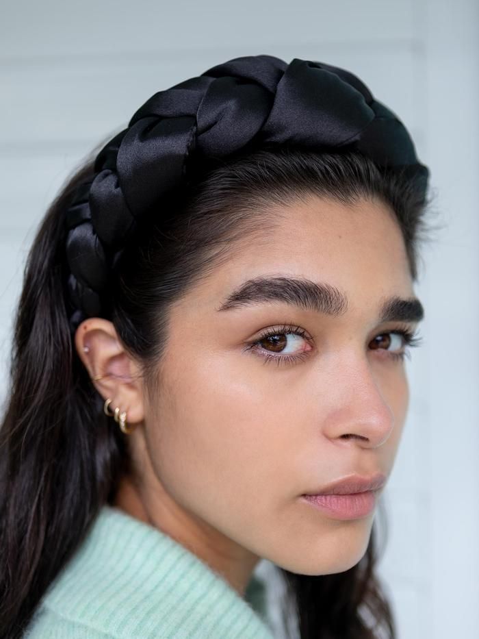 A satin braided headband made specifically for thick hair textures