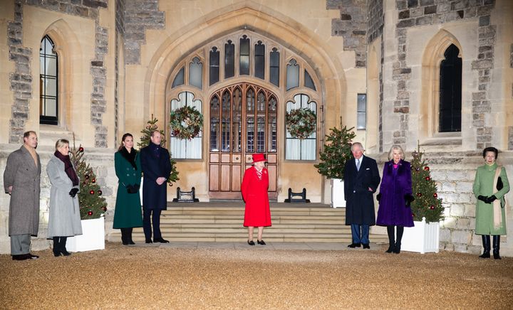 The royals wait in the quadrangle of Windsor Castle last year to thank local volunteers and key workers for their efforts during the coronavirus pandemic and during the holiday season.
