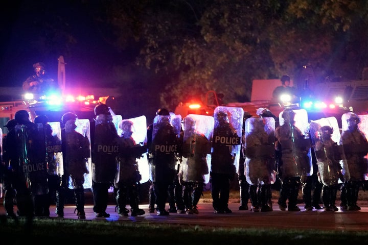 Law enforcement in riot gear line up in Wisconsin in October 2020 after a prosecutor declines to file charges against a police officer who shot a teenager.